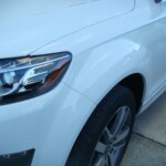 Before and after photographs of a damaged white, AUDI Quattro SUV that was repaired by Elite Paint & Body Shop in West Palm Beach, Florida.